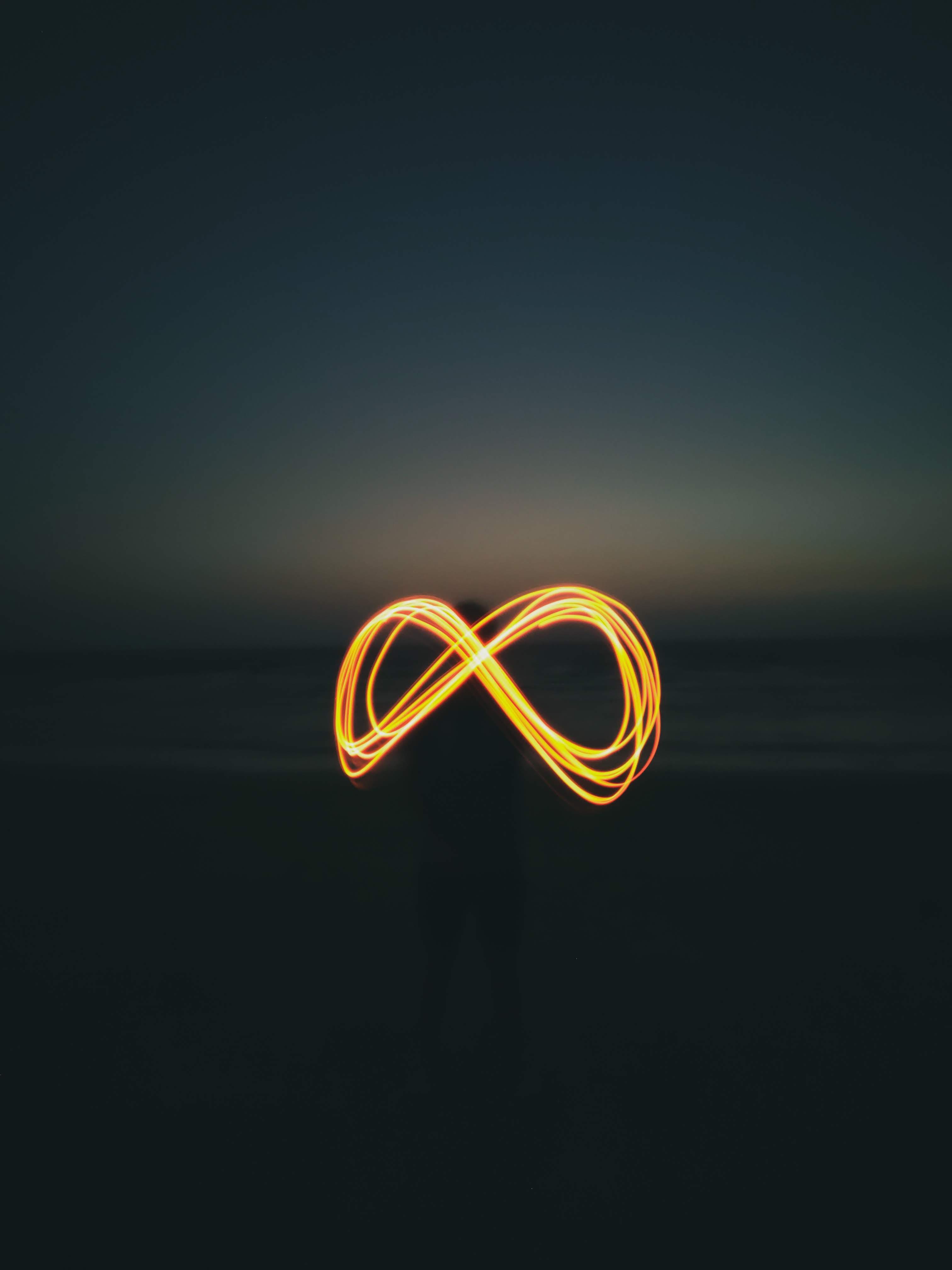 person holding string lights on opened book