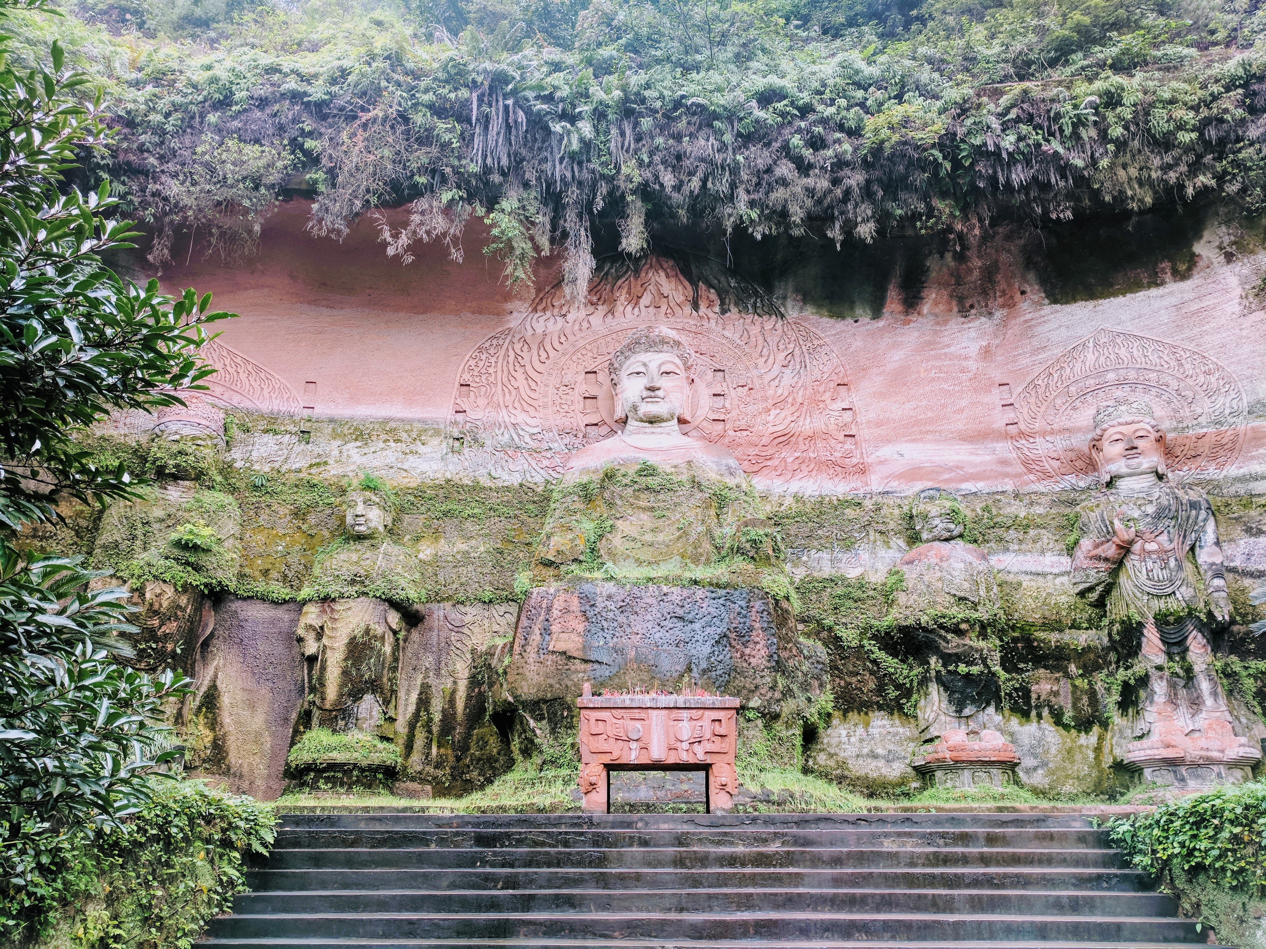 brown and green statue near trees