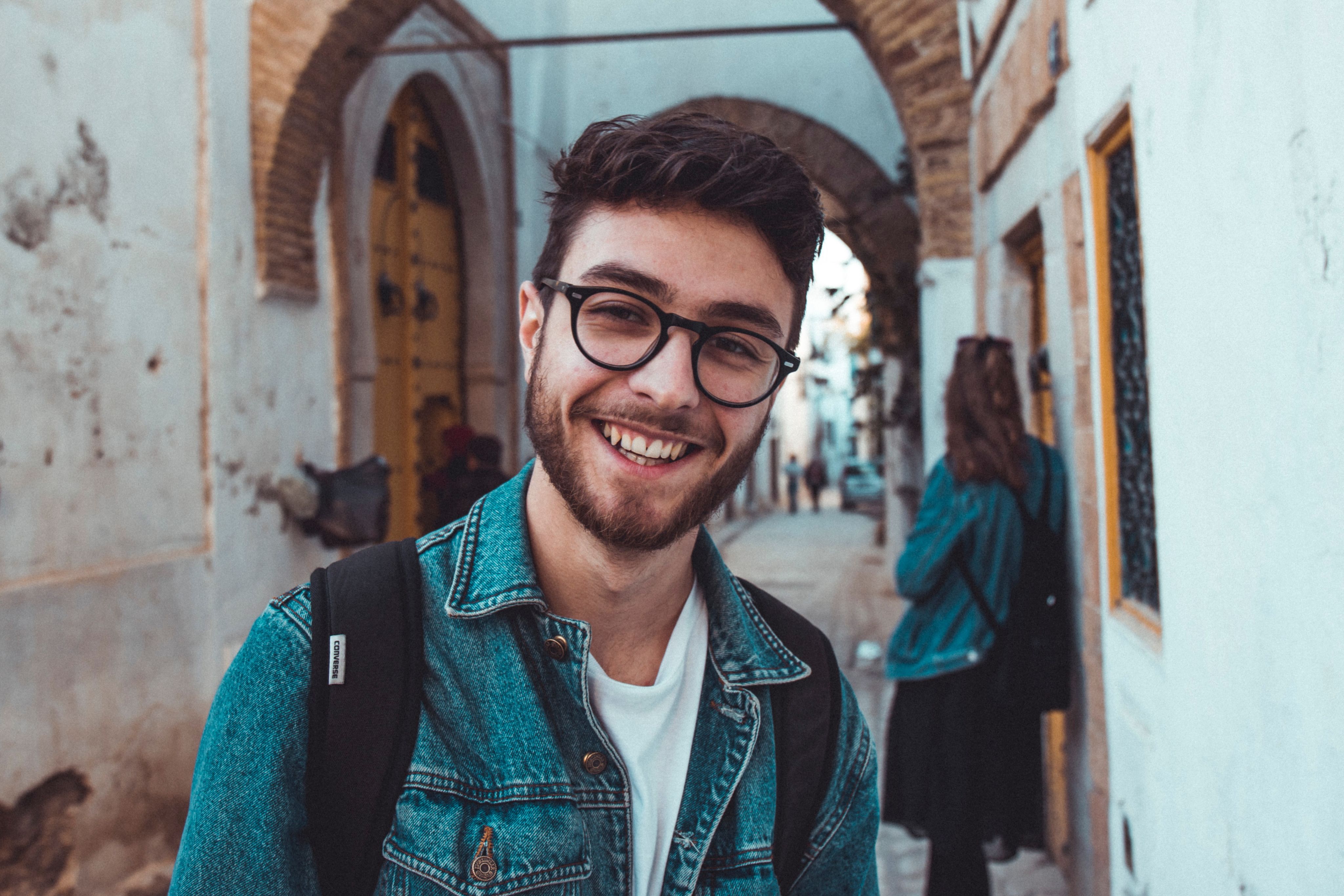 smiling man standing near building