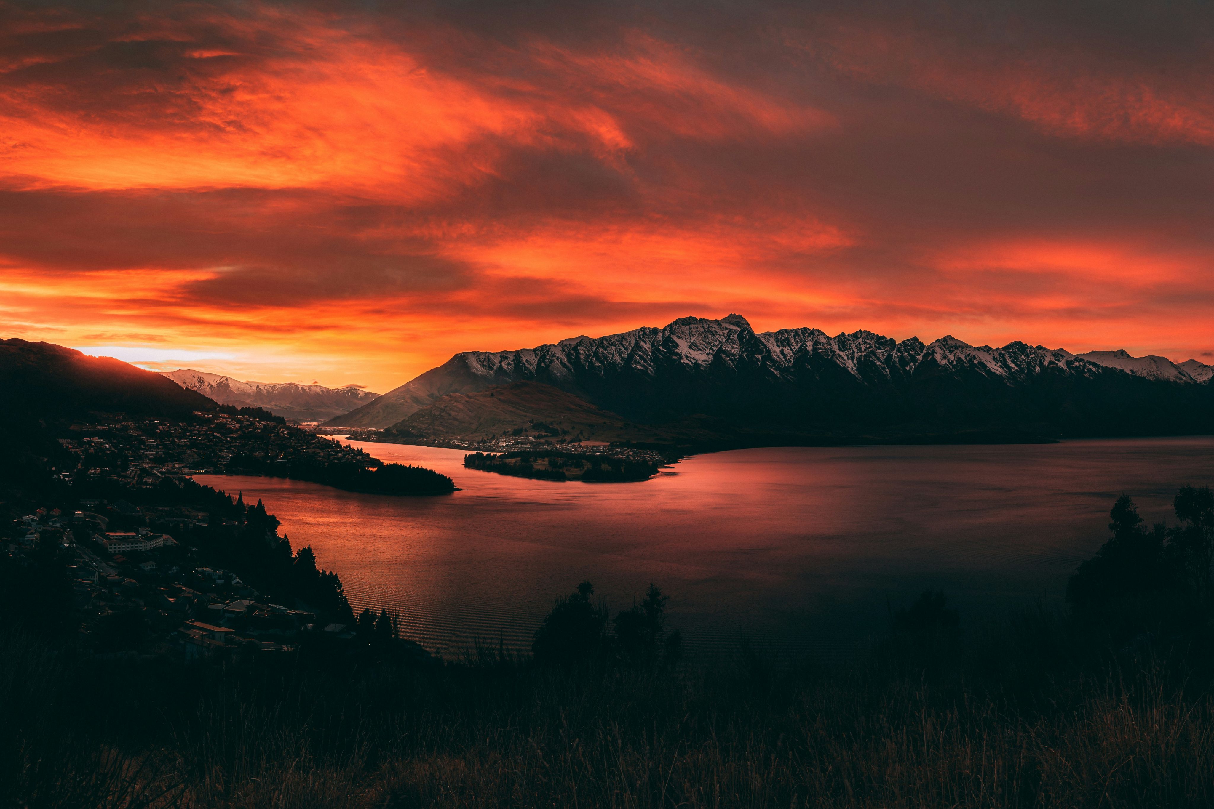 body of water near mountains at golden hour