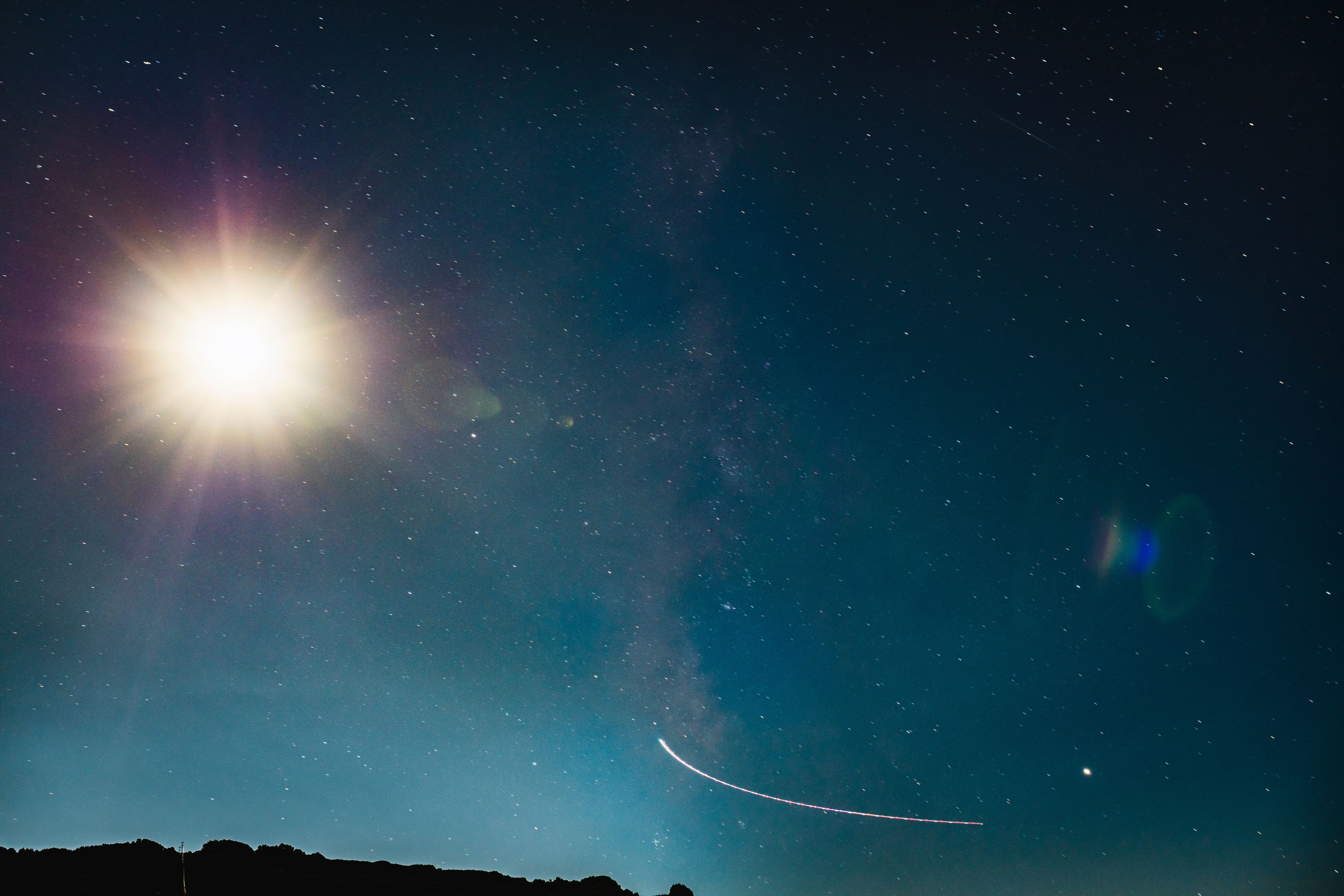 silhouette of mountain under blue sky during night time